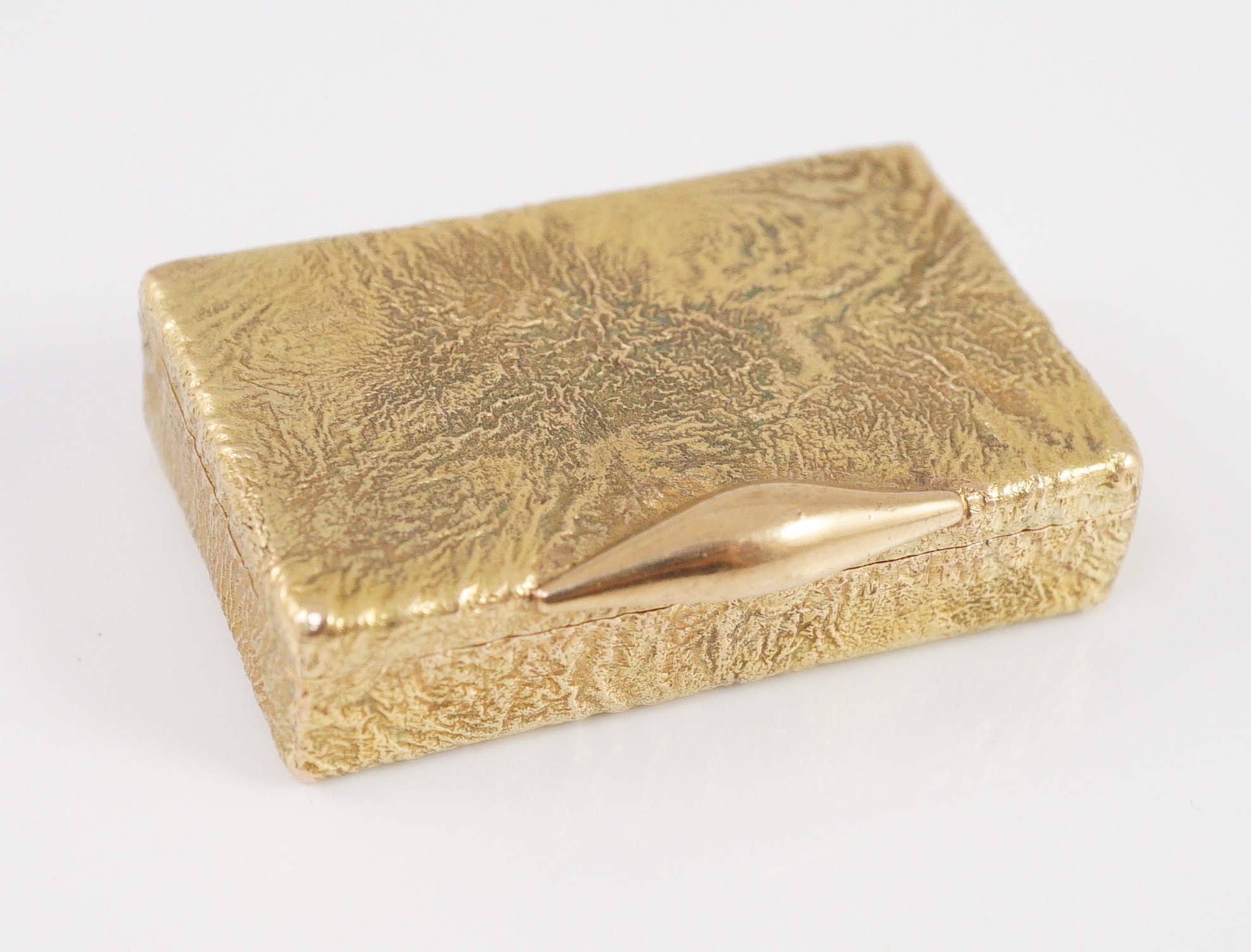 A 1960's 9ct gold Cartier rectangular pill box, with samorodok decoration